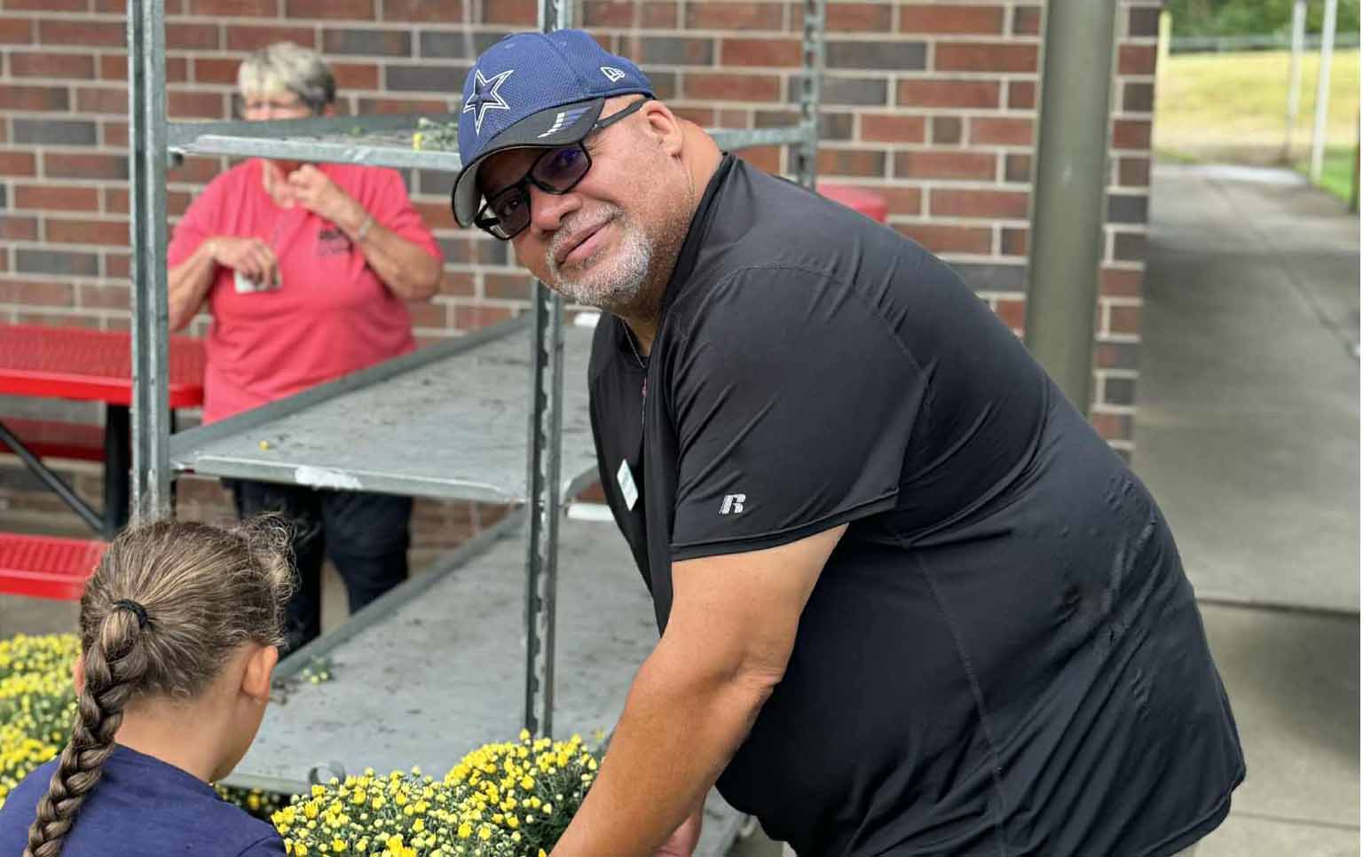 Frank Moore helping load flowers for a community event