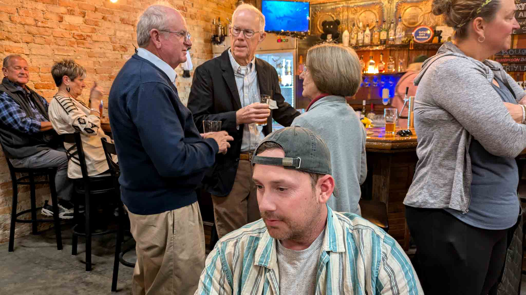 Frank Moore speaking with community members at the brewery