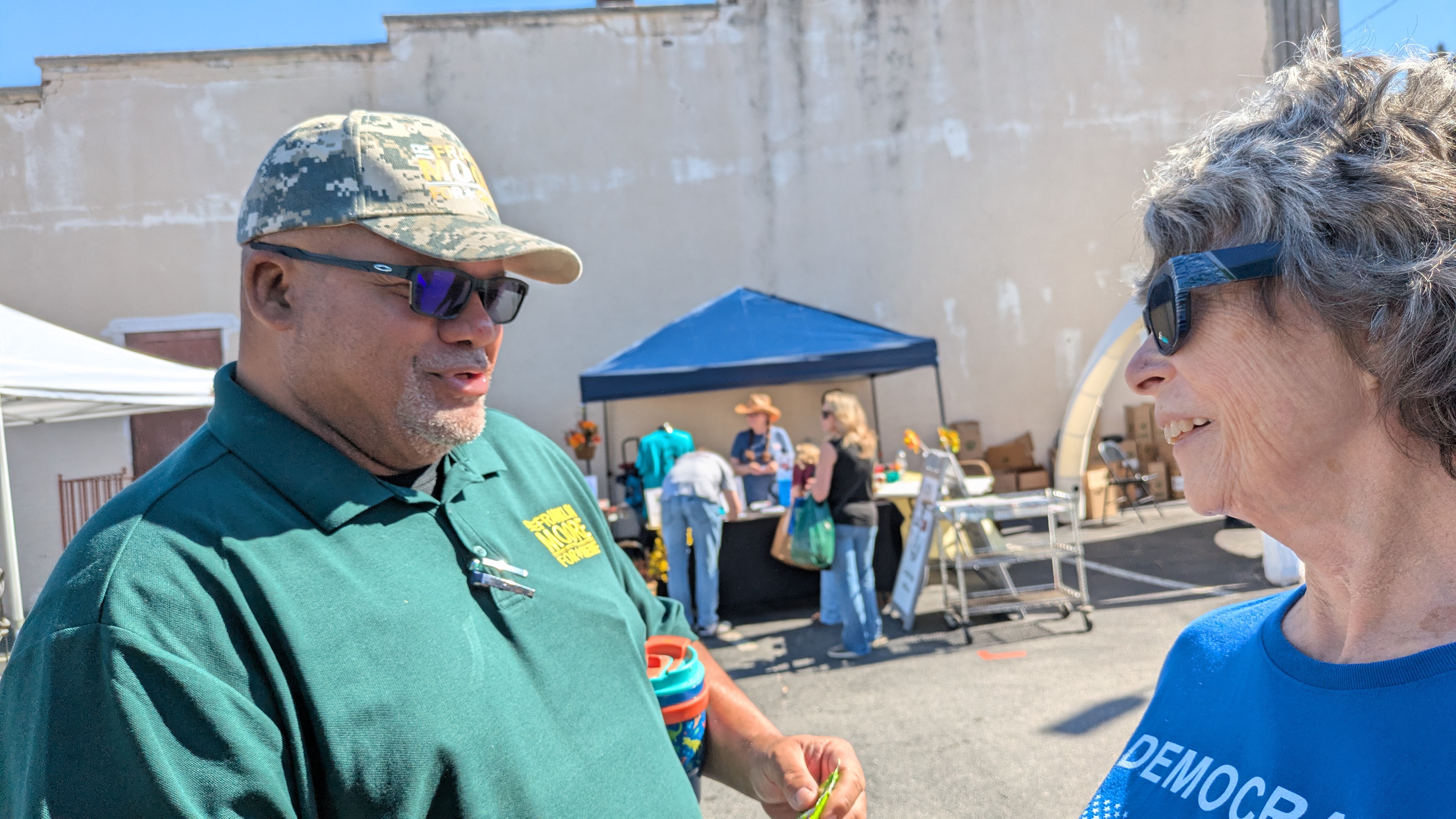 Frank talking with a voter in blue at the festival