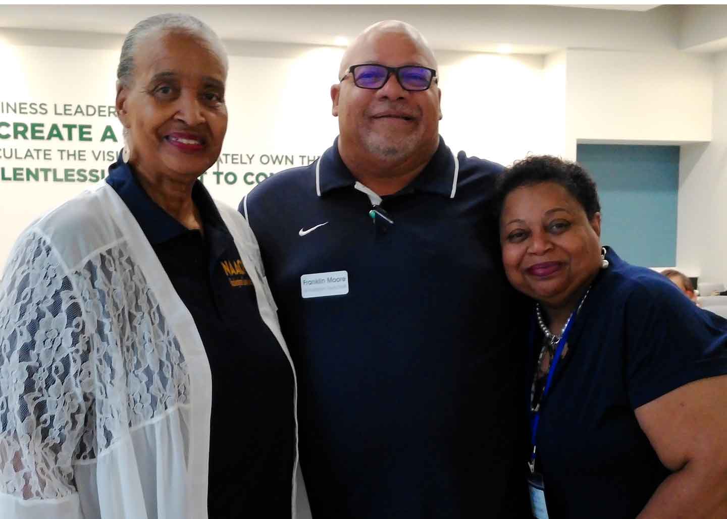 Frank sharing a moment with two smiling attendees