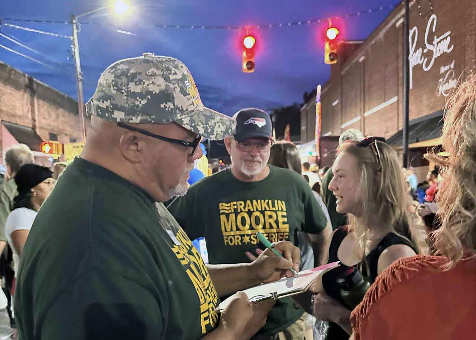 Frank signing campaign materials for supporter Ryan